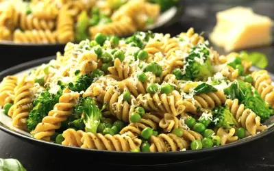 Pyszny makaron z groszkiem i brokułami, posypany parmezanem. Idealny na lekki obiad.