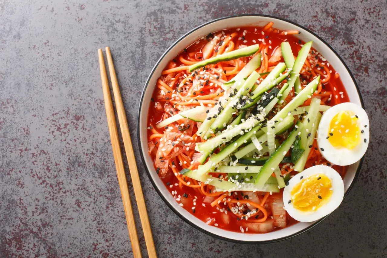 Pyszne koreańskie noodle w pikantnym sosie, z ogórkiem, jajkiem i sezamem. Idealne na szybki posiłek.