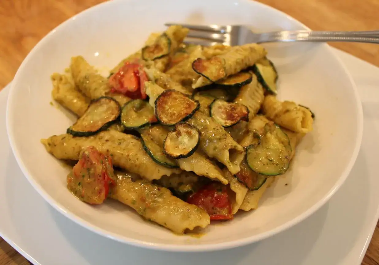 Pyszne makaron garganelli z cukinią i pomidorkami w sosie pesto. Idealne danie na szybki obiad.